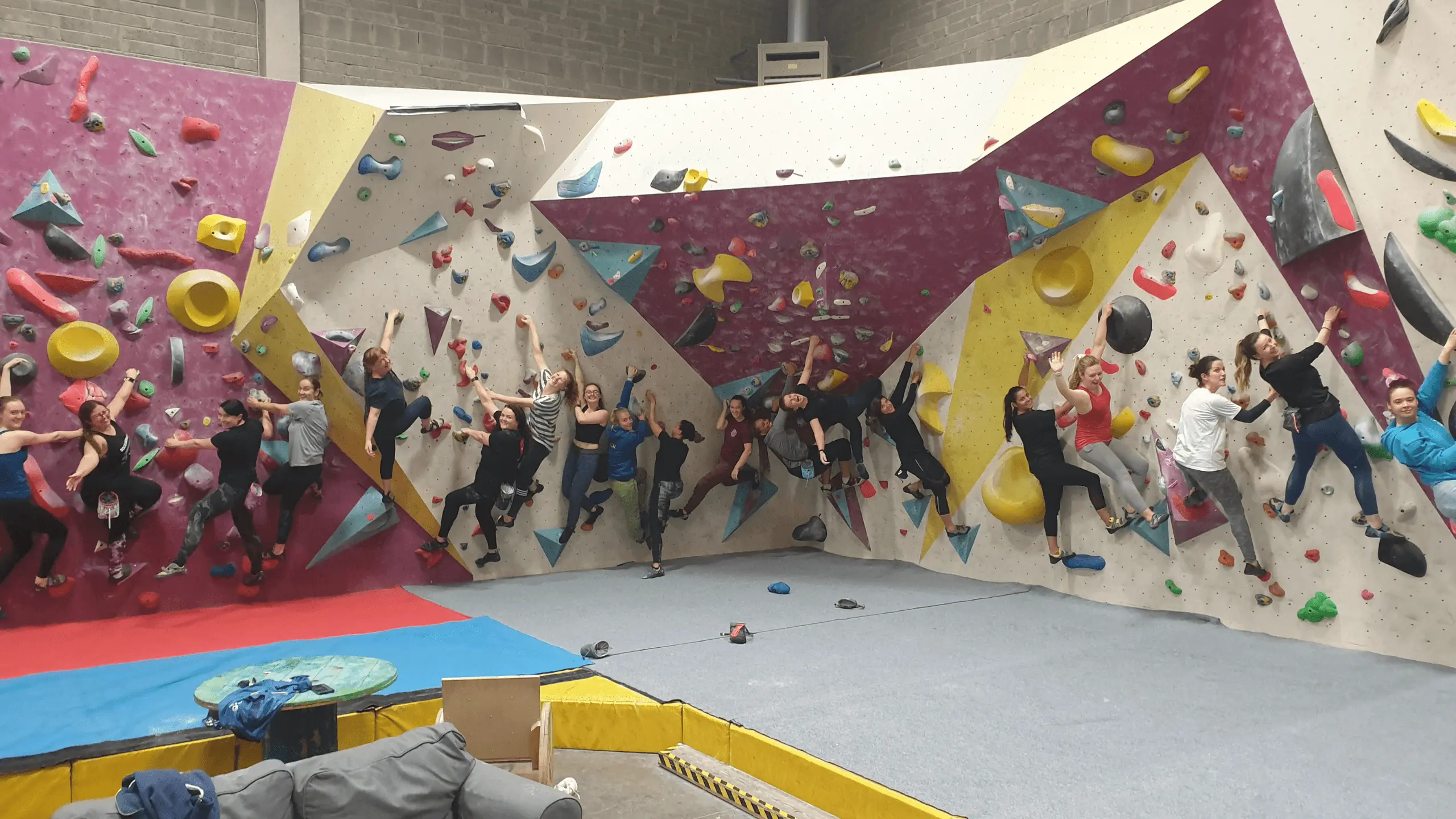 A group of women climbing on the bouldering wall