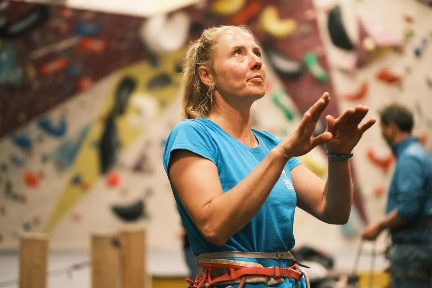 A female instructor giving guidance to a climber at Dublin Climbing Centre