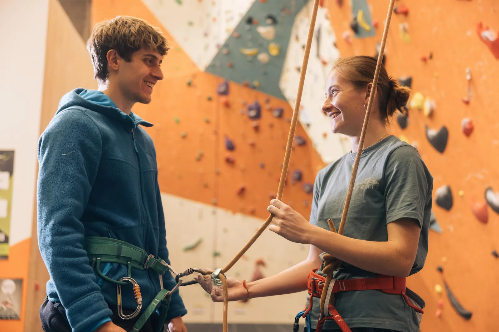 A climber checks their belayer's gear before climbing during a top-rope induction at Dublin Climbing Centre