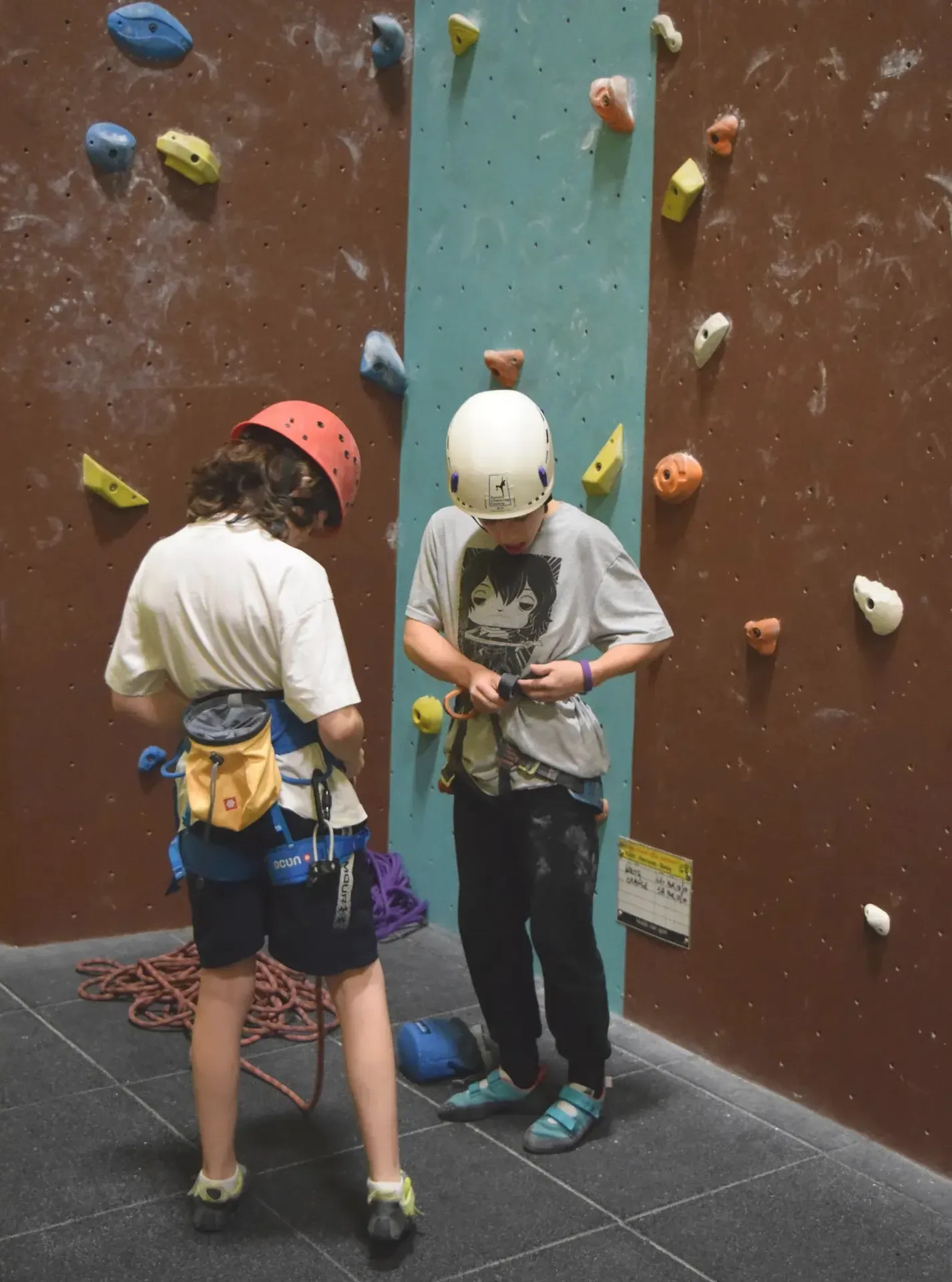 Young climbers tying into their harnesses in a NICAS course at Dublin Climbing Centre