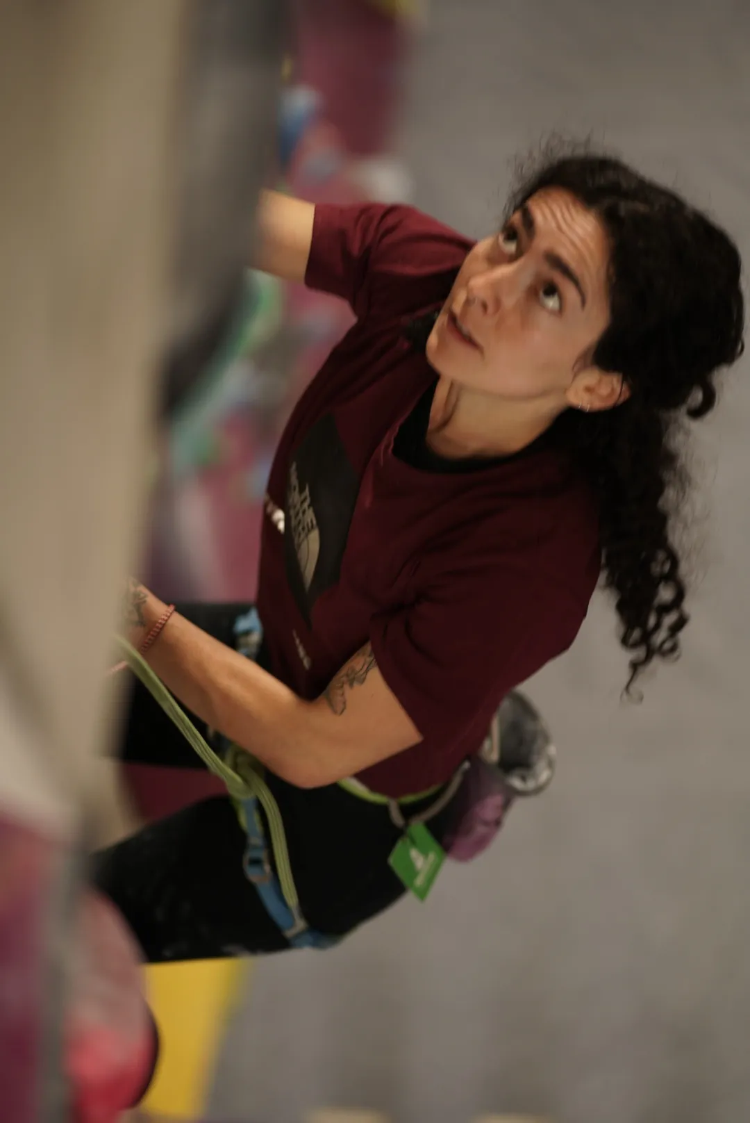 A woman looks upwards towards her next move during a taster climbing session at Dublin Climbing Centre