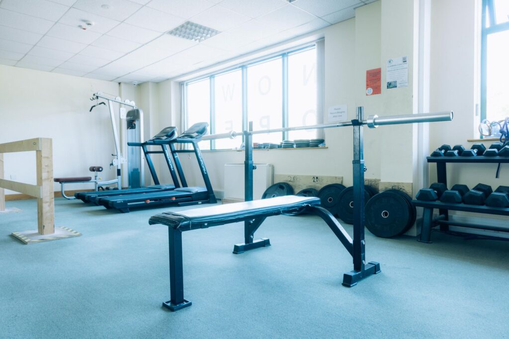 Weight bench, barbell rack, and dumbbells in the weights room at Dublin Climbing Centre