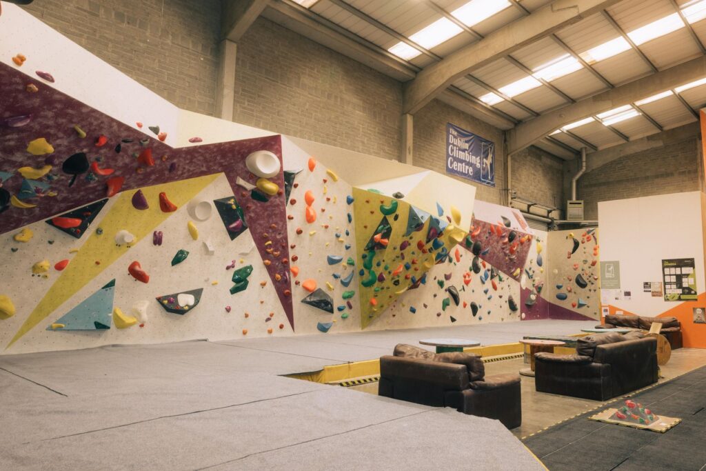 A photo of the bouldering wall at Dublin Climbing Centre with various climbing routes