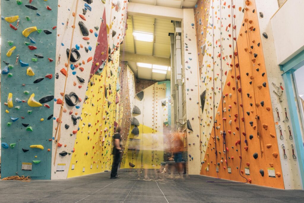 Tall lead and bouldering walls with climbers at Dublin Climbing Centre
