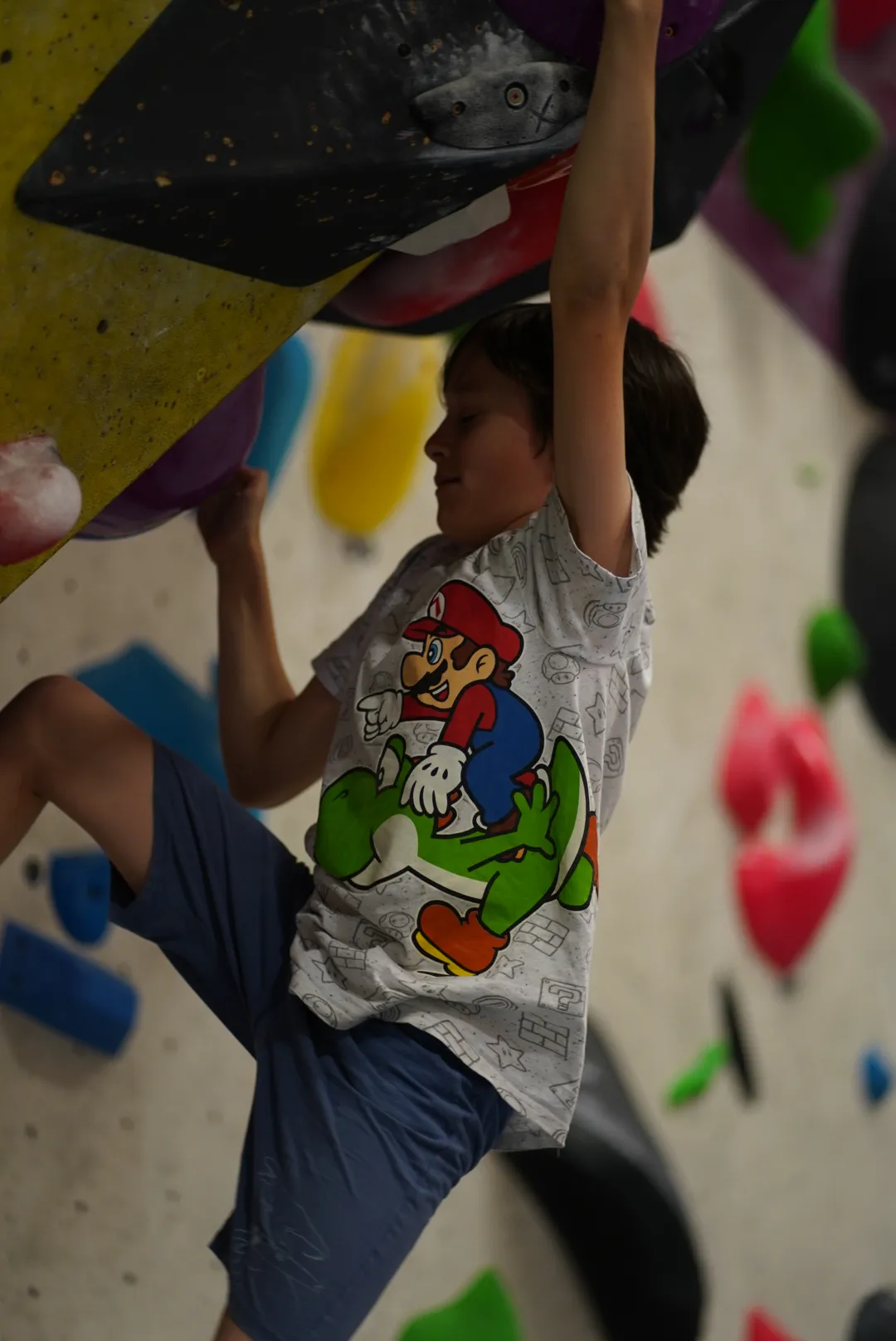 A young child bouldering at the Dublin Climbing Centre indoor camp