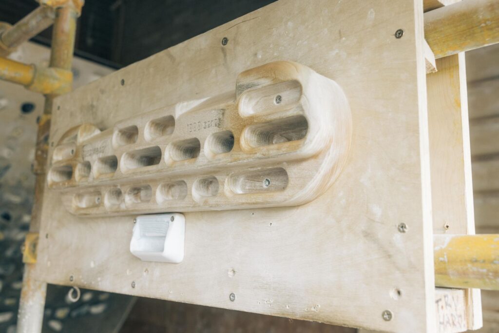 Close-up of a wooden fingerboard in the training room at Dublin Climbing Centre