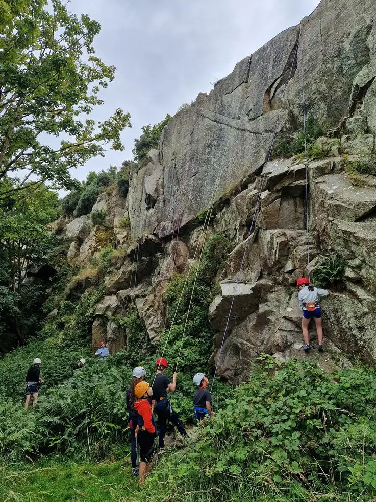 Young climbers on real rock at Dalkey Quarry outdoor climbing camp with Dublin Climbing Centre