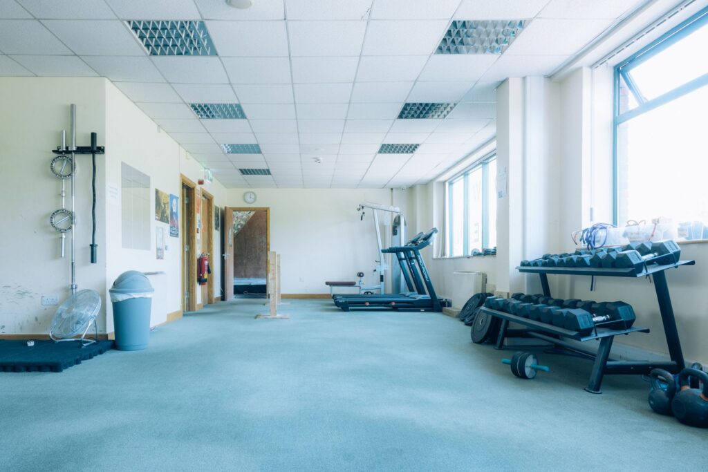 Weights room with dumbbell racks, treadmill, and free weights at Dublin Climbing Centre