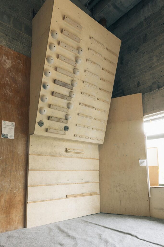 Angled wooden training board with holds and rungs at Dublin Climbing Centre
